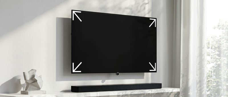 TV upphängd på väggen med pilar som indikerar storleken